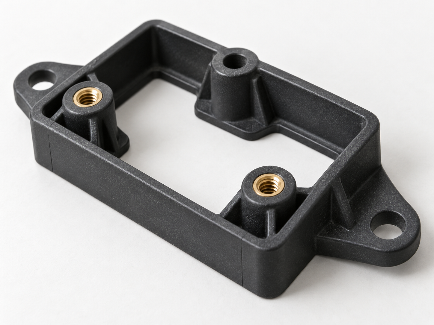 Brass inserts positioned within a machined injection mold cavity